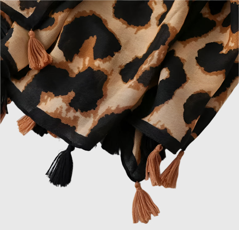 This is a stunning fashion scarf, featuring a bold and modern panther pattern in a classic camel color that adds an edgy yet sophisticated touch to any outfit. Crafted from a luxurious blend of natural fabrics, including soft viscose and breathable cotton, this scarf offers both comfort and style. The combination of these fabrics provides a lightweight feel, perfect for year-round wear, while the sleek panther design makes a statement wherever you go.