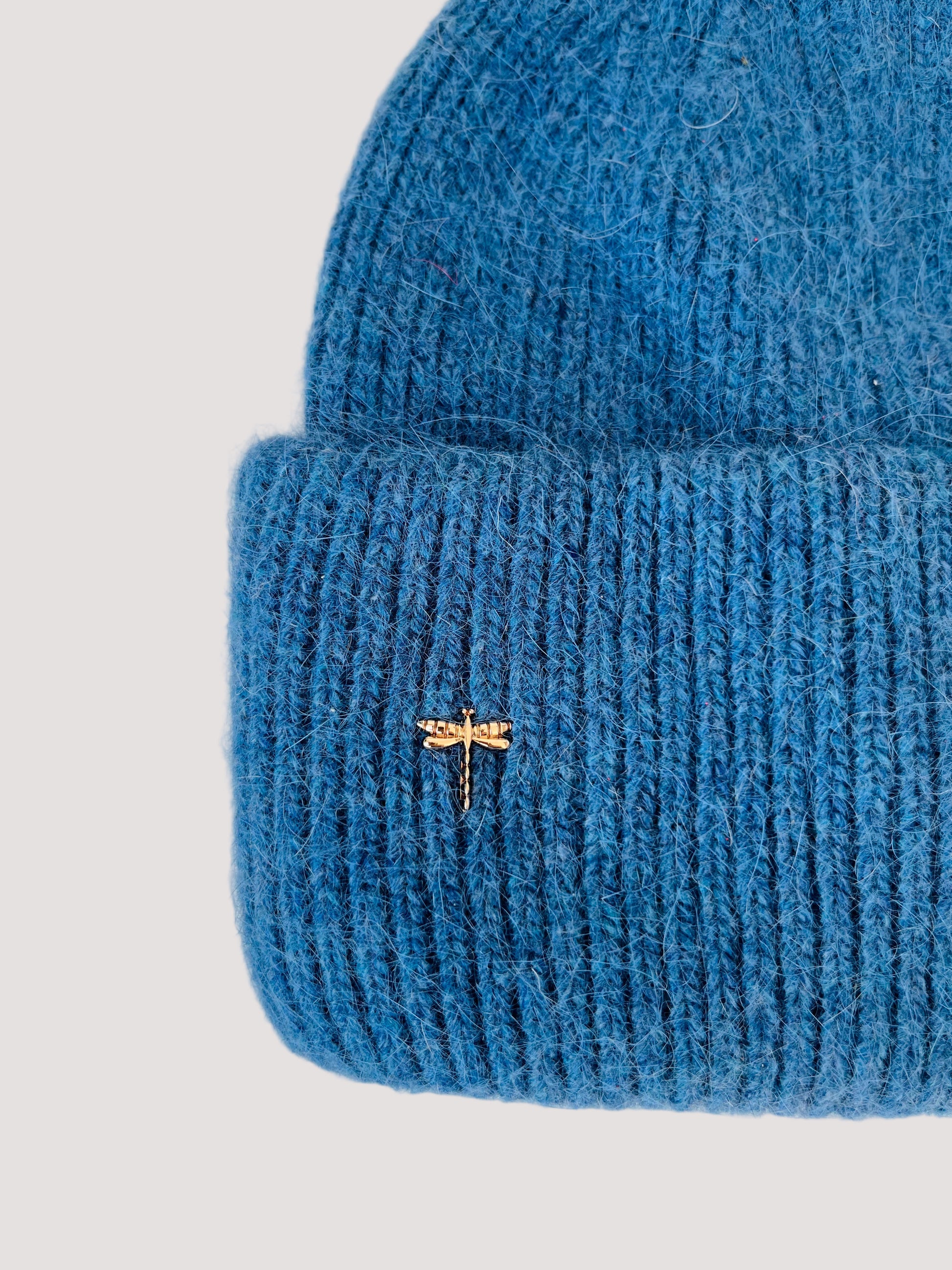Blue knit angora beanie in cornflower blue color with an elegant dragonfly brooch on the side