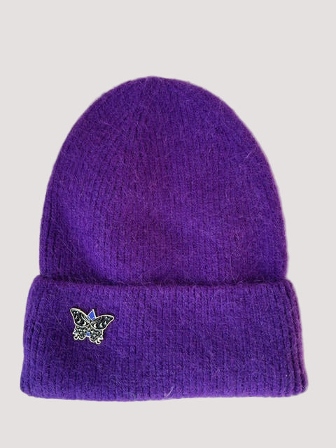 Purple knit angora beanie with a butterfly emblem on a white background