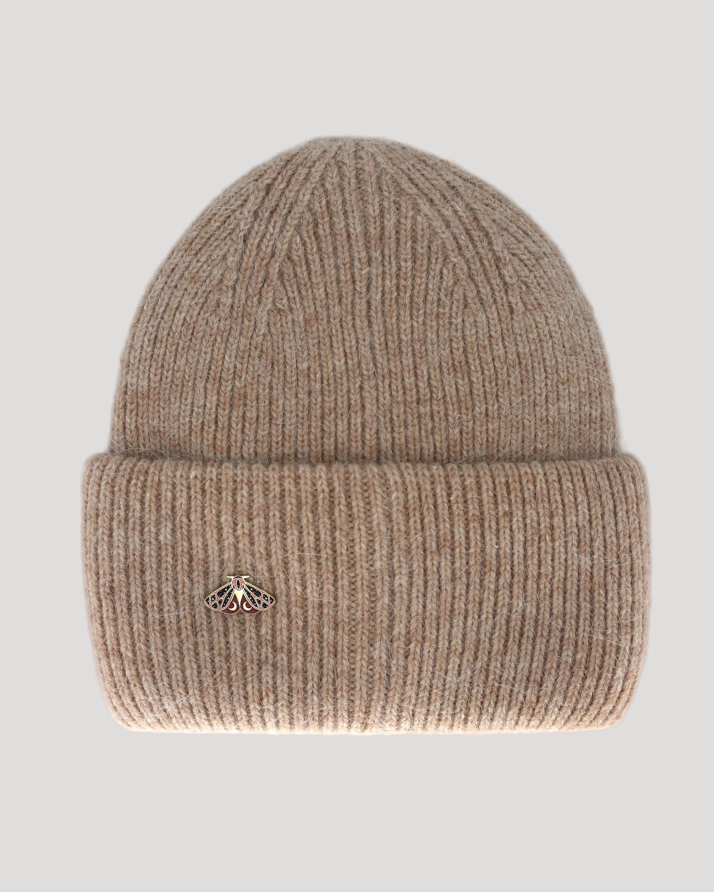 A beige beanie hat made of angora and wool, displayed on a neutral background.