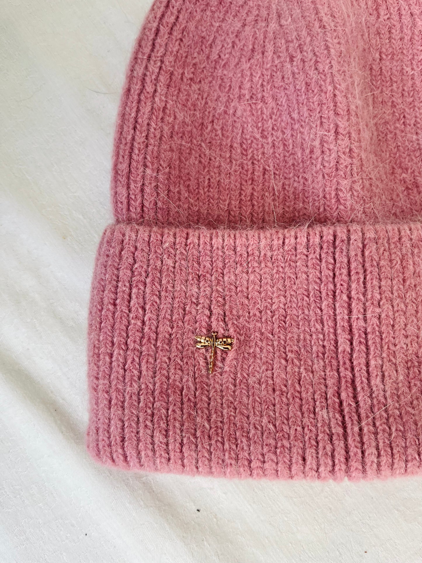 This Hat is a finest hat with a classic silhouette. A luxurious accessory for women made from the softest natural angora and sheep wool for extreme comfort and warmth. It is made in a trendy pale pink color accompanied by an elegant pin.