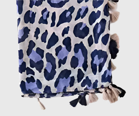 This is a stunning fashion scarf, featuring a bold and modern panther pattern in a fresh lilac and navy color combination crafted from a luxurious blend of natural fabrics, including soft viscose and breathable cotton, this scarf offers both comfort and style.