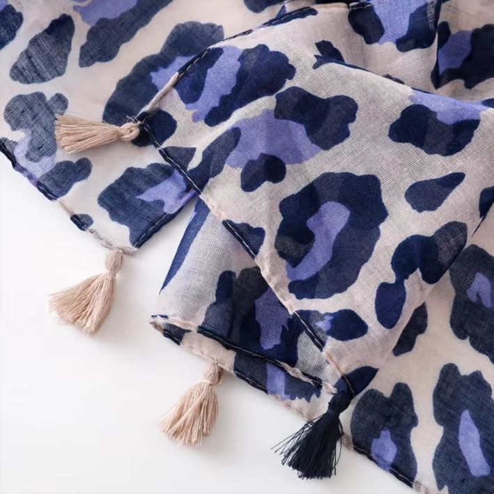 This is a stunning fashion scarf, featuring a bold and modern panther pattern in a fresh lilac and navy color combination crafted from a luxurious blend of natural fabrics, including soft viscose and breathable cotton, this scarf offers both comfort and style.