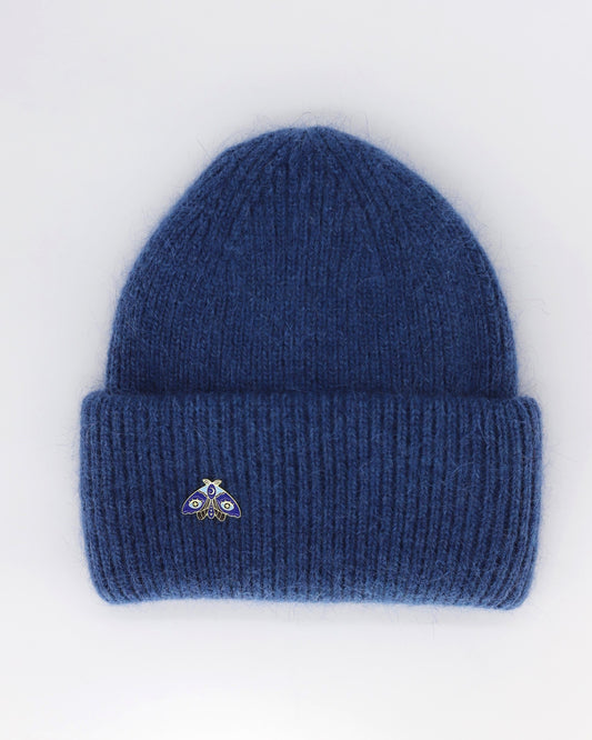 This Hat is a finest hat with a classic silhouette. A luxurious accessory for women made from the softest natural angora and sheep wool for extreme comfort and warmth. It is made in a trendy navy blue color accompanied by an elegant pin. This product is sourced and manufactured in Poland