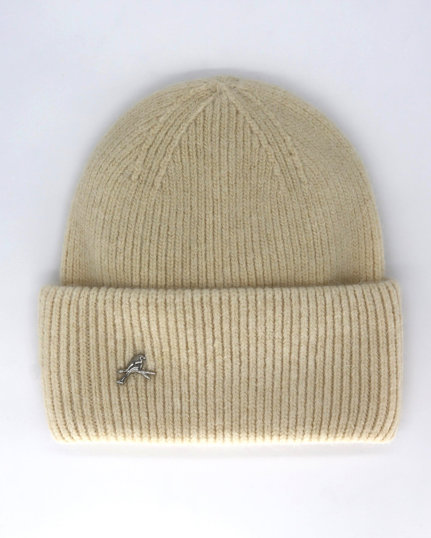 This Hat is a finest hat with a classic silhouette from Villanelle. A luxurious accessory for women made from the softest natural angora and sheep wool for extreme comfort and warmth. It is made in a trendy cream color accompanied by an elegant pin. This product is sourced and manufactured in Poland.