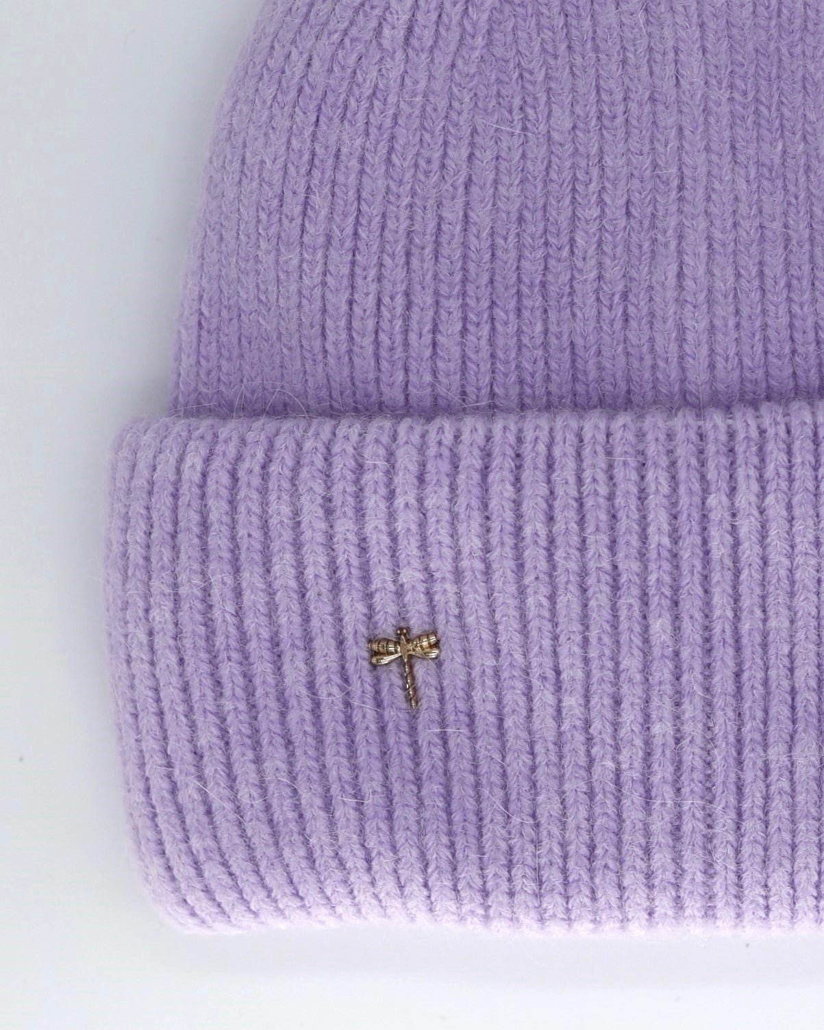 This Hat is a finest hat with a classic silhouette from Villanelle. A luxurious accessory for women made from the softest natural angora and sheep wool for extreme comfort and warmth. It is made in a trendy lavender color accompanied by an elegant pin. This product is sourced and manufactured in Poland.