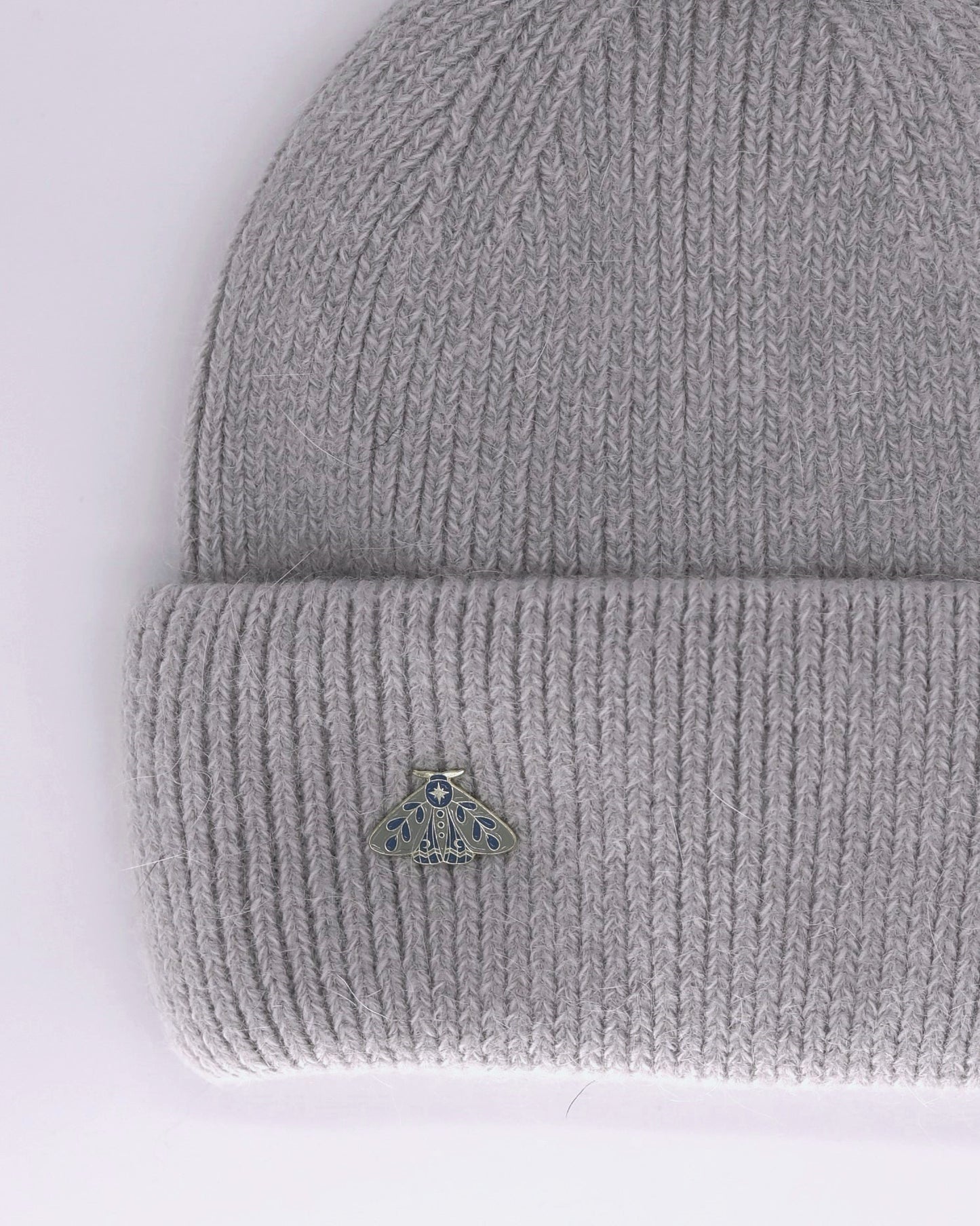 This Hat is a finest hat with a classic silhouette. A luxurious accessory for women made from the softest natural angora and sheep wool for extreme comfort and warmth. It is made in a trendy light grey color accompanied by an elegant pin. This product is sourced and manufactured in Poland.