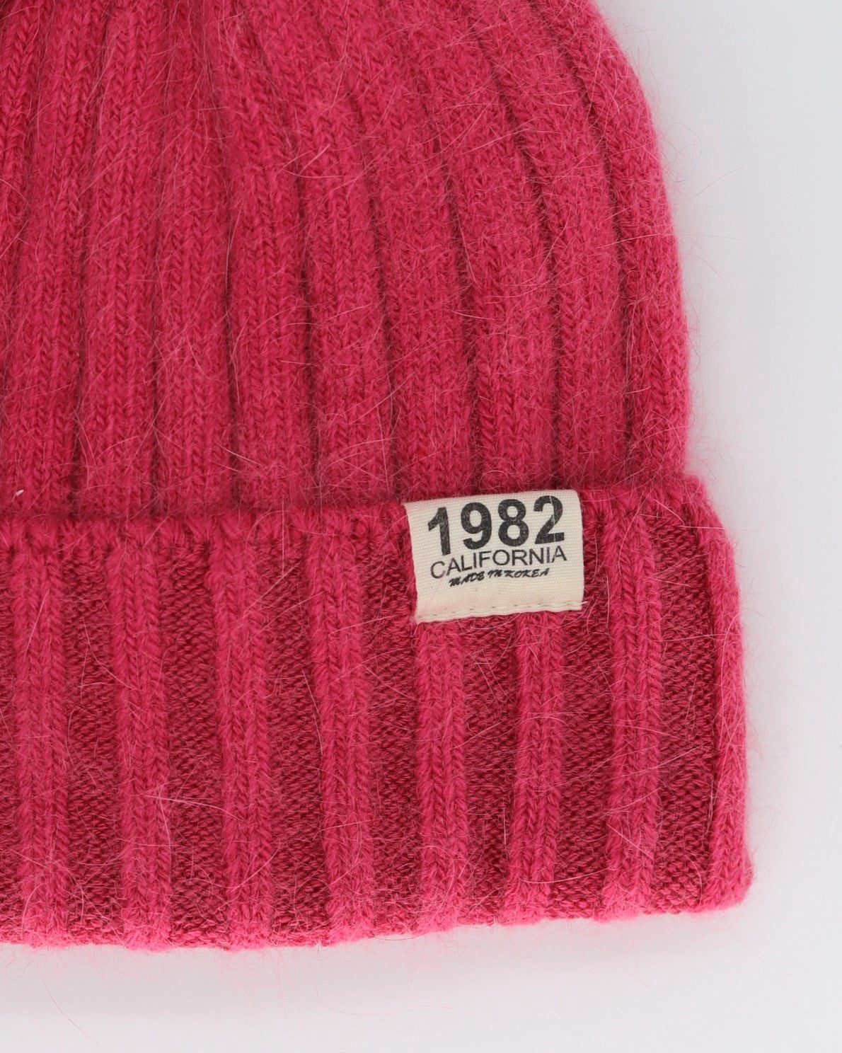 This Beanie is a finest hat with a classic silhouette from Villanella. A luxurious accessory for women made from the softest natural wool, cashmere and viscose for extreme comfort and warmth. It is made in a trendy raspberry pink color accompanied by an elegant pin. This product is sourced and manufactured in Poland.