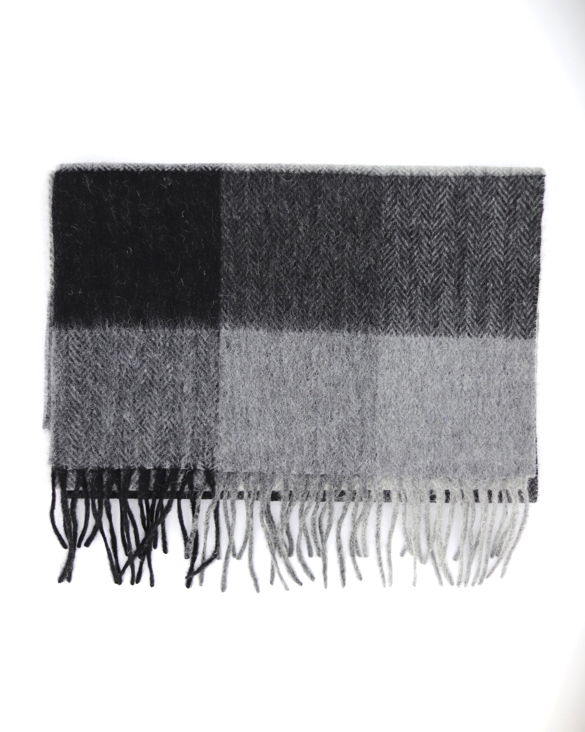 This Scarf is a finest 100% natural Australian wool scarf in a classic checked pattern from Villanelle. A luxurious accessory for women and for men and made from the softest natural wool for extreme comfort and warmth. It is made in a trendy combination of grey, black and creamy color. This product is sourced in Australia and manufactured in Poland.