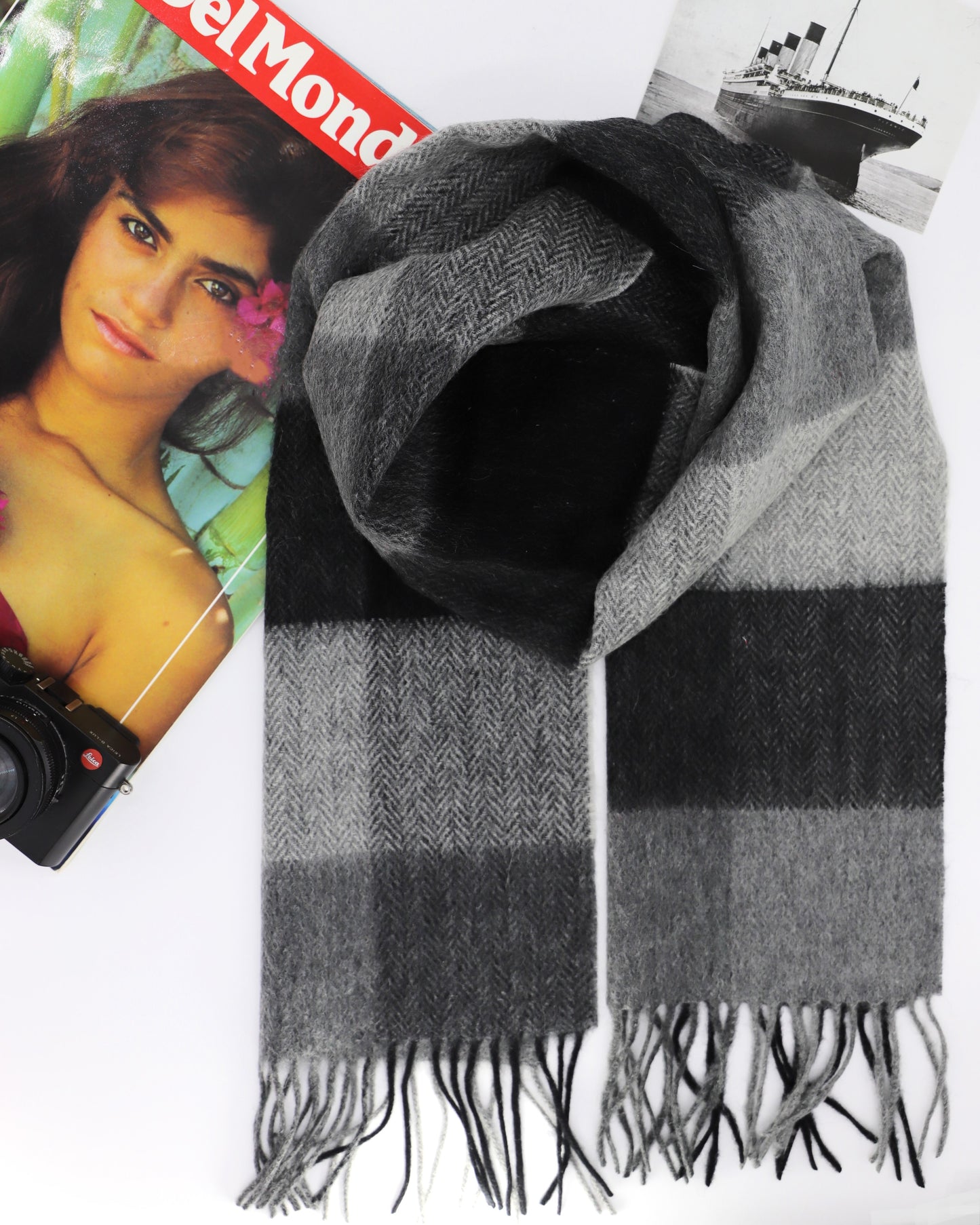 This Scarf is a finest 100% natural Australian wool scarf in a classic checked pattern from Villanelle. A luxurious accessory for women and for men and made from the softest natural wool for extreme comfort and warmth. It is made in a trendy combination of grey, black and creamy color. This product is sourced in Australia and manufactured in Poland.