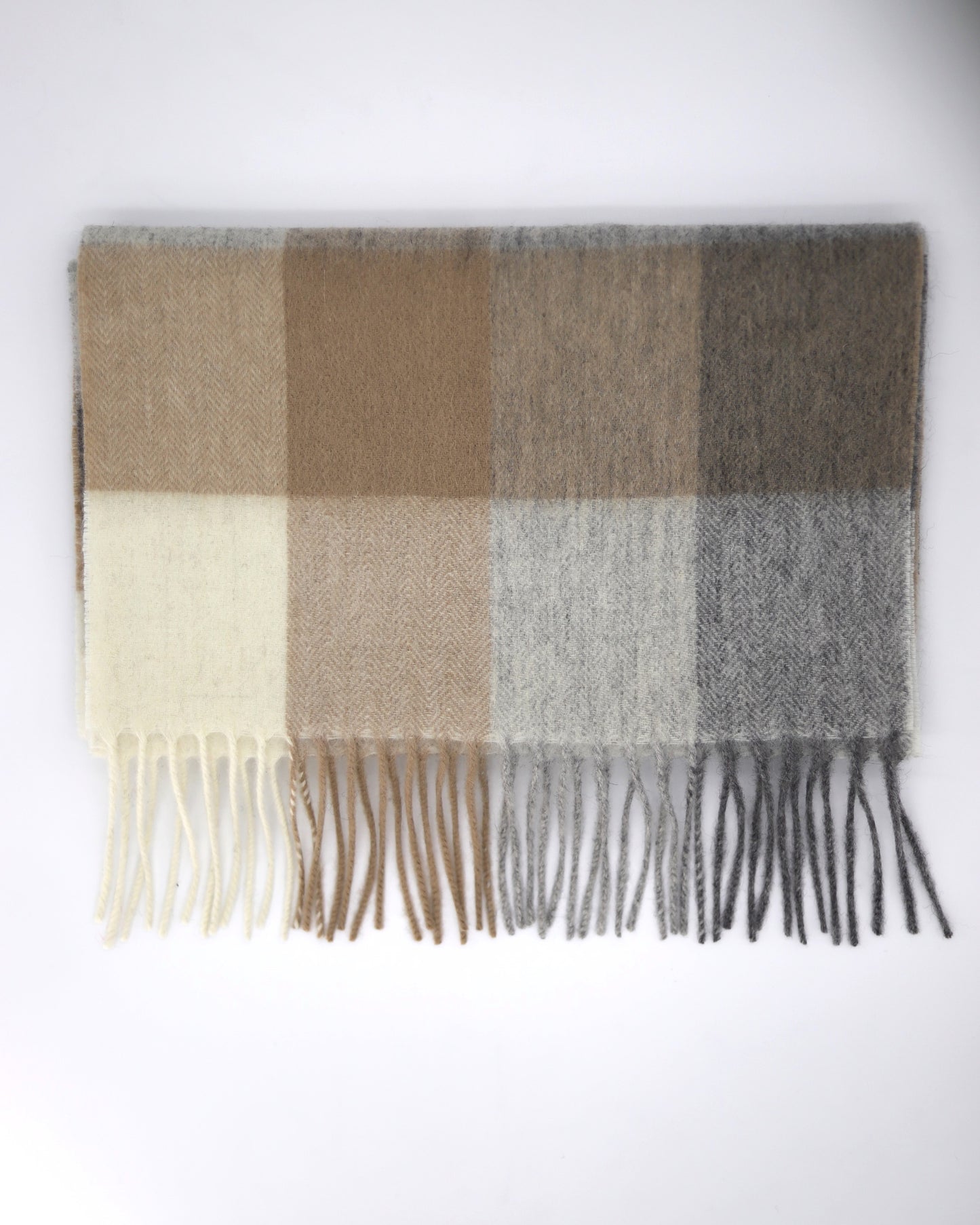 This Scarf is a finest 100% natural wool scarf in a classic checked pattern from Villanelle. A luxurious accessory for women and made from the softest natural wool for extreme comfort and warmth. It is made in a trendy combination of light grey, beige and creamy color. This product is sourced and manufactured in Poland.