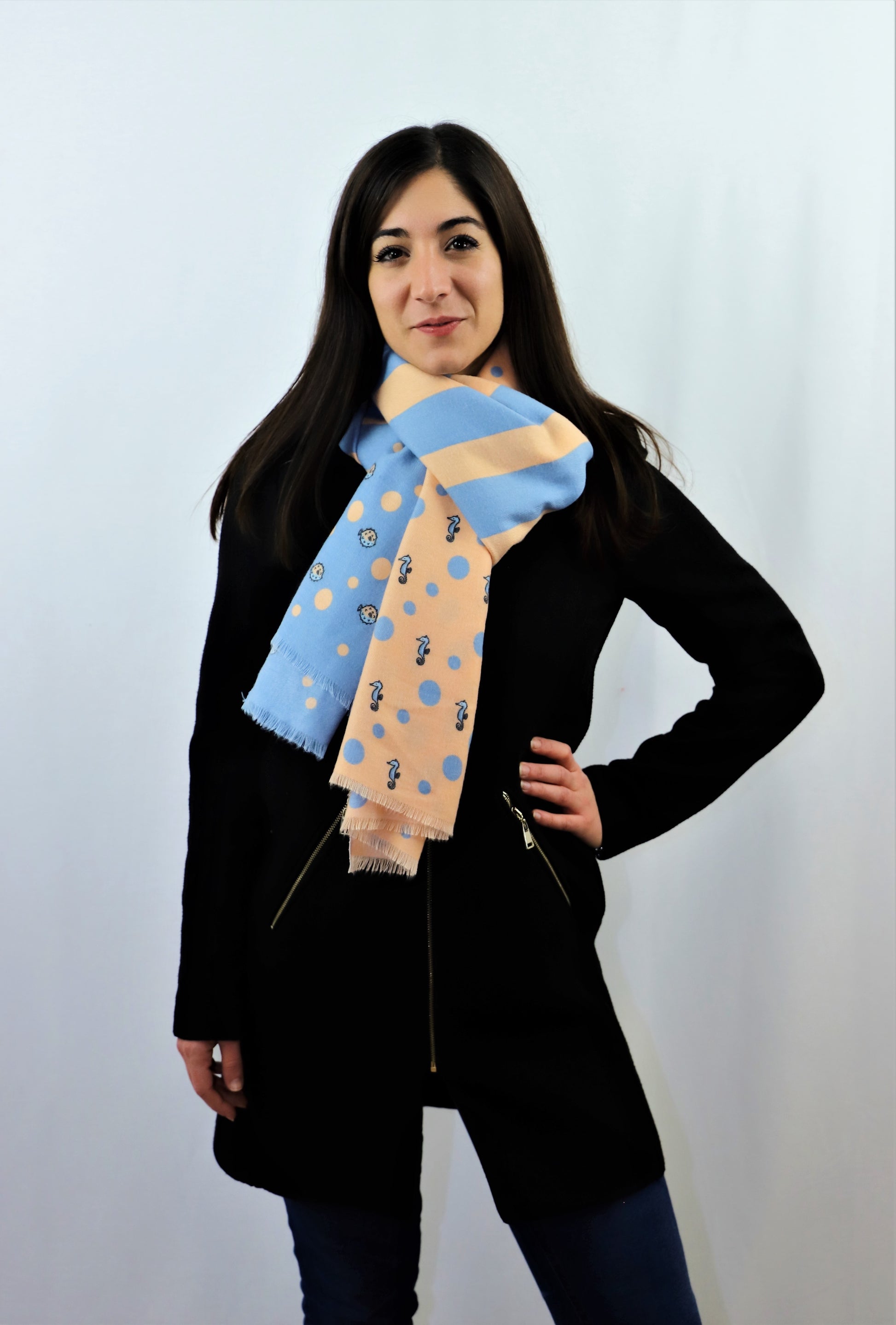 This is a warm and soft cotton scarf for women in beige and blue in unique marine, ocean patterns with fish and seahorse design made from a special cotton blend that gives you a wonderful cashmere-like feeling without hurting animals. This is a vegan and cruelty-free scarf certified by PETA and a perfect gift idea for women.