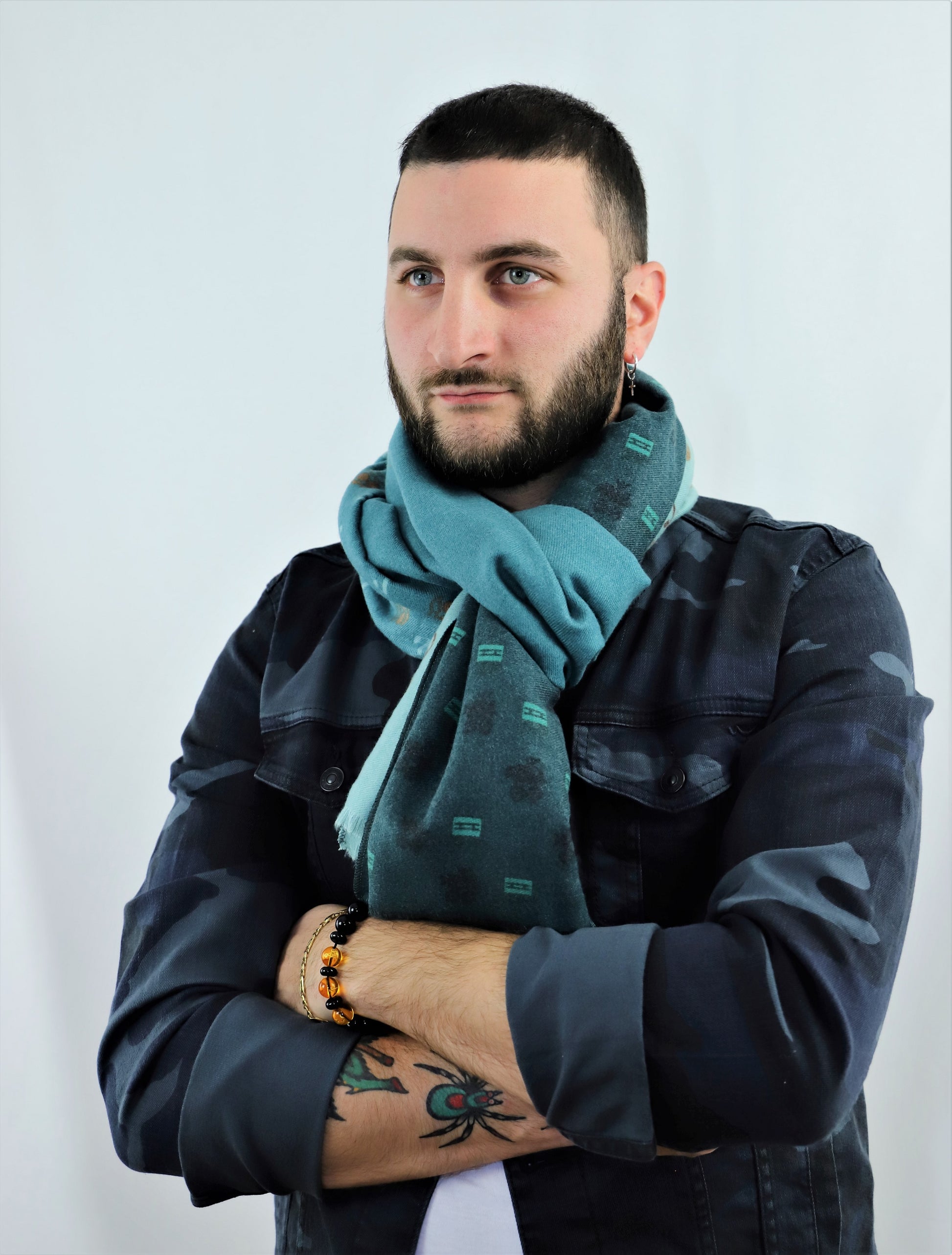This is a soft and warm cotton scarf for men and for women with unique patterns of headphones, camera and vinyl disc in three shades of green and brown made from a special cotton blend that gives you a wonderful cashmere-like feeling without hurting animals. This is a completely vegan scarf certified by PETA and a perfect gift idea for both men and women.
