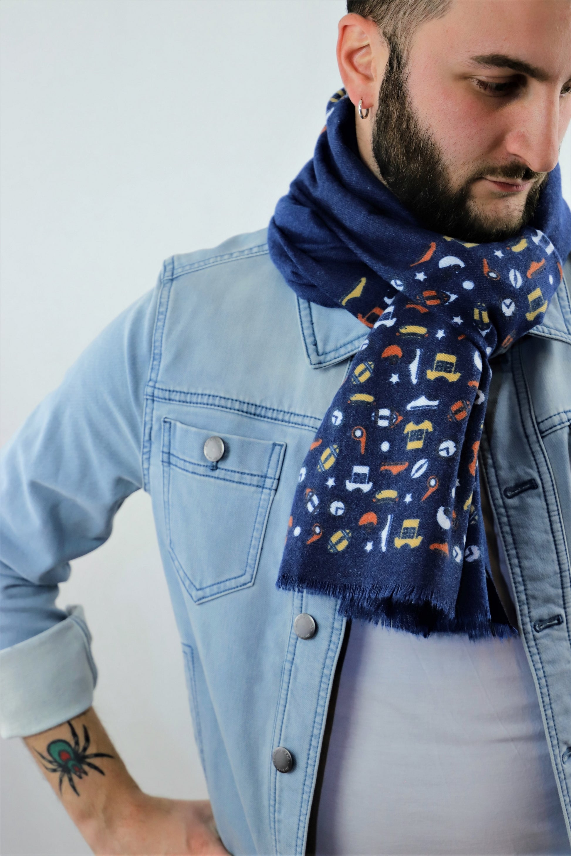 This is a warm and soft cotton scarf for men in navy blue color with unique patterns of rugby elements made from a special cotton blend that gives you a wonderful cashmere-like feeling without hurting animals. This is a completely vegan and cruelty free scarf certified by PETA and a perfect gift idea for both men.